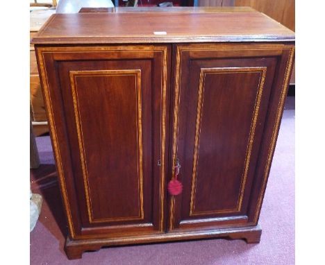 An early 19th century mahogany side cabinet, with boxwood inlay, raised on bracket feet, H.98 W.86 D.36cm 