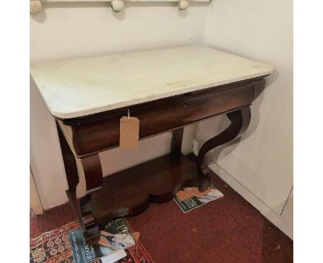A 19th century mahogany console table, with marble top above one drawer, raised on sabre legs and shaped base, H.85 W.92 D.54