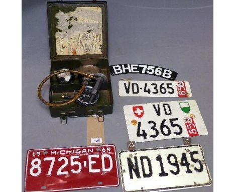 A WWII Jeep medical box together with a Redex compression gauge, Smiths clock, amperes and 5 vintage number plates 