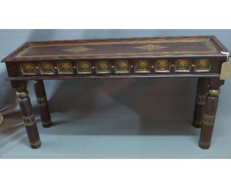An Indian teak and brass mounted console table, having floral embossed brass panels, H.77 W.150 D.45cm 