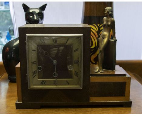 A Art Deco mantle clock with Austrian Art Deco spelter figurine of naked lady mounted to one side.