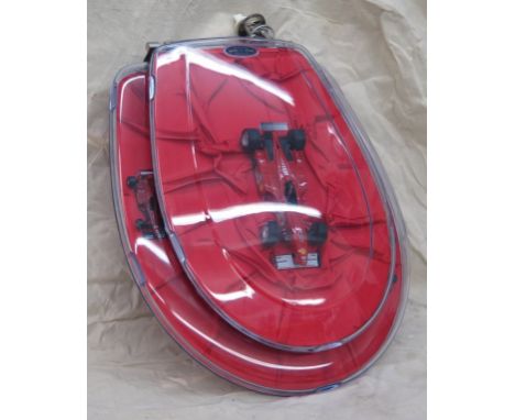 A Ferrari themed toilet seat as manufactured by Elista &amp; Heinzl, and entitelled 'Red Satin'. in fine and unused condition