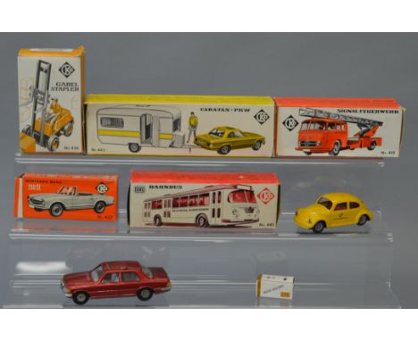 Five boxed tinplate models by CKO including a Ford Capri with Caravan and a Fork Lift Truck. Two unboxed models are also incl