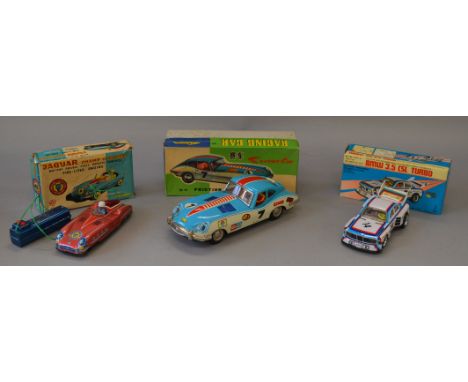 Three boxed toy cars of tinplate and plastic construction, a large Chinese friction  'Racing Car', and a Japanese battery ope