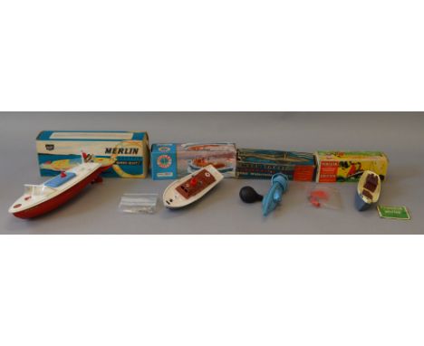 Four boxed model boats of plastic and tinplate construction by various British manufacturers including Tri-ang, Sebel and Sut