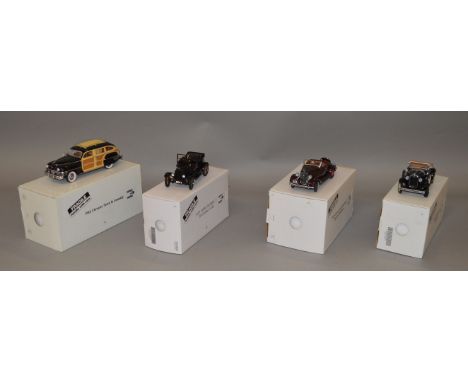 Four boxed Danbury Mint diecast model cars in 1:24 scale, 1925 Ford Model T Touring Car, 1927 Ford Model A Clock, 1935 Chevro