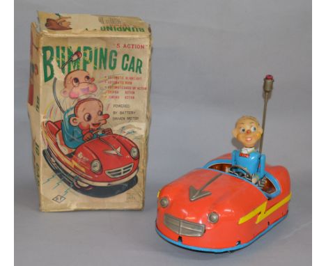 A boxed tinplate battery operated ' 5 Action Bumping Car' by Alps (Japan). Although untested, the model appears complete with