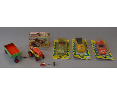 A boxed GAMA tinplate tank together with an unboxed GAMA Tractor and Trailer, with some damage. Three carded Huki topmod (Ger