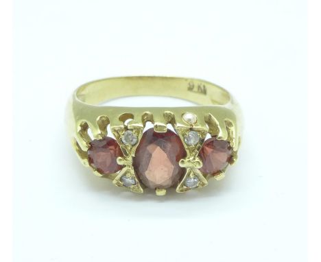 A 9ct gold, three red stone and four white stone ring, 3.1g, O