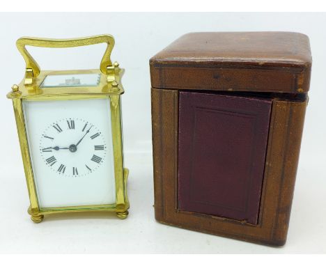 A brass and four glass sided carriage clock in a leather covered case, dial cracked