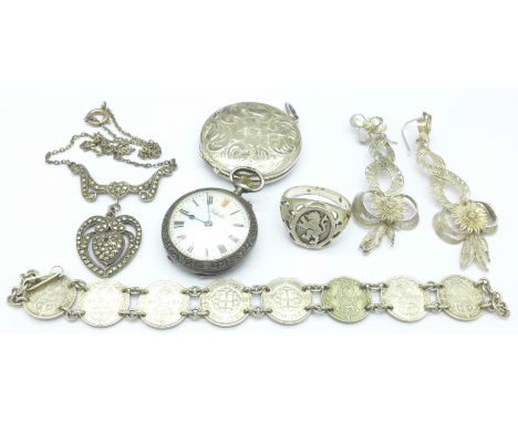 A silver and marcasite necklet, a silver 3d coin bracelet, a silver ring, a silver fob watch, a silver locket and filigree ea