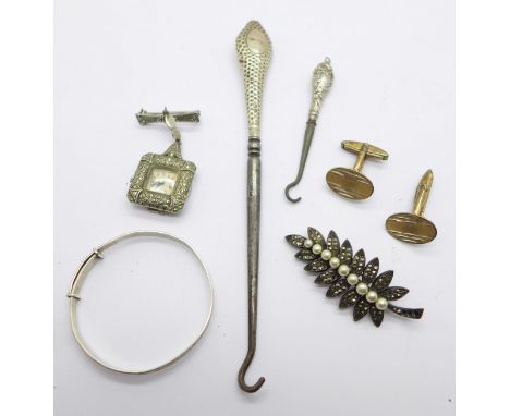 A pair of 9ct gold on silver cufflinks, a silver baby's bangle, a silver button hook, a marcasite and silver brooch watch, a 
