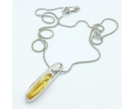 An 18ct gold, stone and diamond set pendant on an 18ct white gold chain, 6g