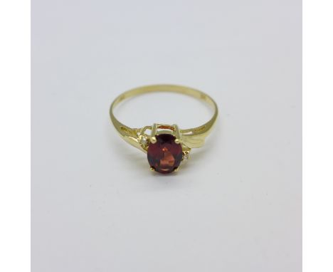 A 9ct gold, garnet and diamond ring, 1.1g, O