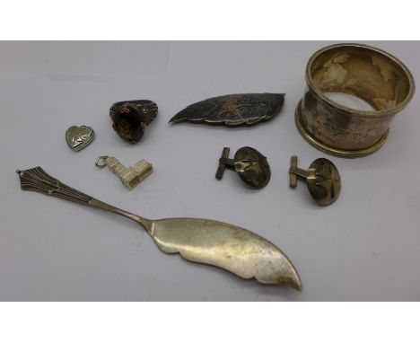 Silver items including a napkin ring, a butter knife, cufflinks, a locket and a niello brooch and charm, 64g