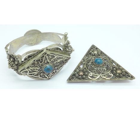 A white metal bangle and large brooch set with turquoise, 51g, brooch 7cm