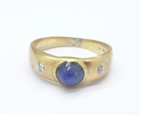 A yellow metal, cabochon sapphire and diamond three stone ring, tests as 14ct, 2.3g, H