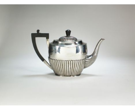 An early 20th century silver teapot, Atkin Brothers, Sheffield 1920, of oval half reeded form with ebonised handle and finial