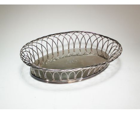 A George III silver bread basket, Joseph Preedy, London 1799, of oval form with stylised arch wirework rim, engraved monogram