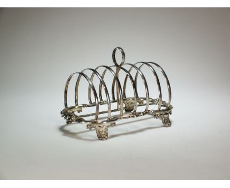 A Victorian silver toast rack, Henry Wilkinson &amp; Co, Sheffield 1852, of six division form with cast floral frame, raised 