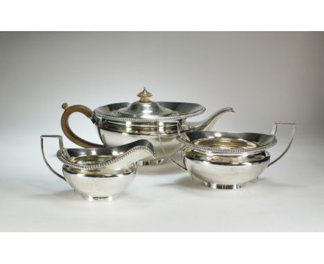 A George V three piece silver tea service, C S Harris &amp; Sons Ltd, London 1912, each piece of circular form with gadrooned