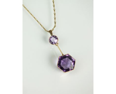 An early 20th century amethyst pendant, designed as a hexagonal faceted amethyst milligrain set in yellow metal suspended fro