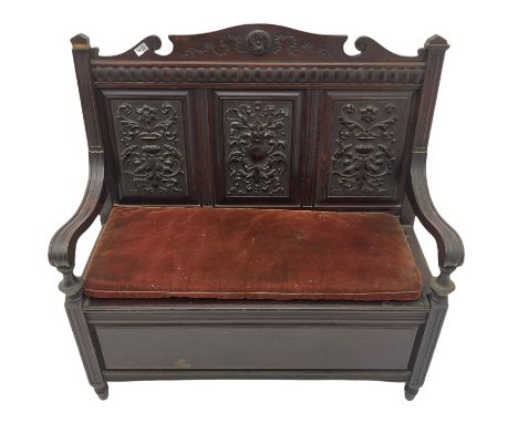 Late 19th century oak settle bench, shaped cresting rail carved with ribbon over triple panelled back, the panels relief carv