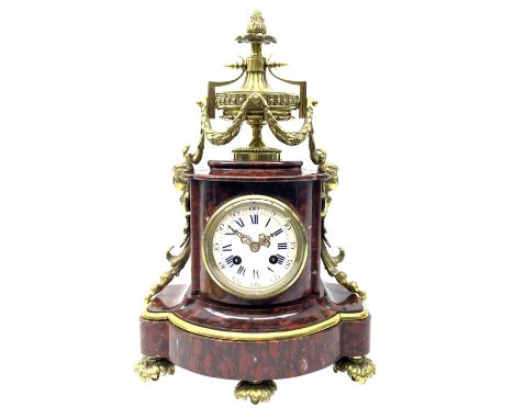 Late 19th century French Royal rouge marble and ormalu mantle clock of shaped bow front form, the fluted ormalu urn decorated