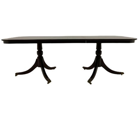 Regency style mahogany twin pedestal dining table, two D-ends and central additional leaf, on turned pedestals with splayed s