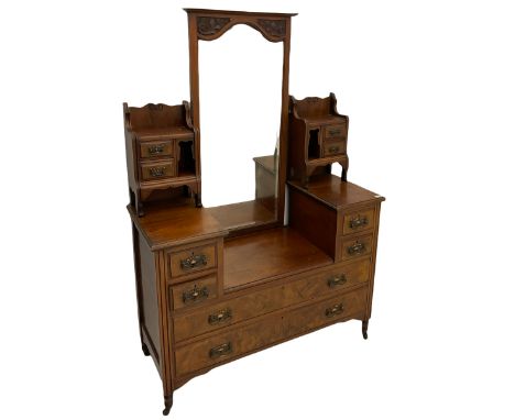 Late 19th century walnut dressing chest, drop centre with raised swing bevelled mirror and small trinket drawers, fitted with