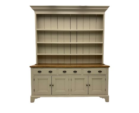 Victorian pine dresser, raised painted three heights plate rack with projecting cornice, waxed top over pained base fitted wi