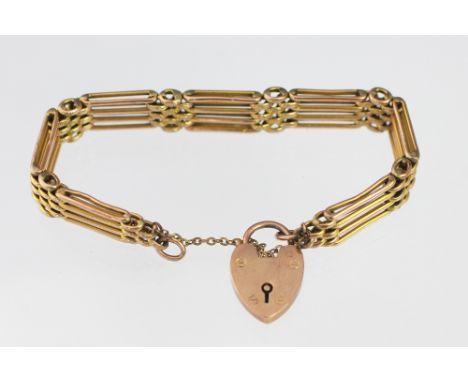 A yellow metal four bar gate bracelet, with attached heart shaped, padlock clasp stamped '9ct Gold', weight 19.8gms 