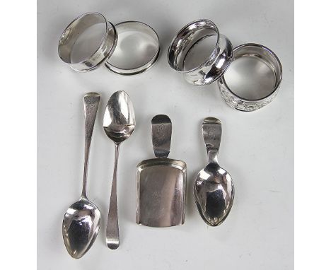 A pair of silver napkin rings, Birmingham 1938, along with two further napkin rings, two spoons and two caddy spoons, total w