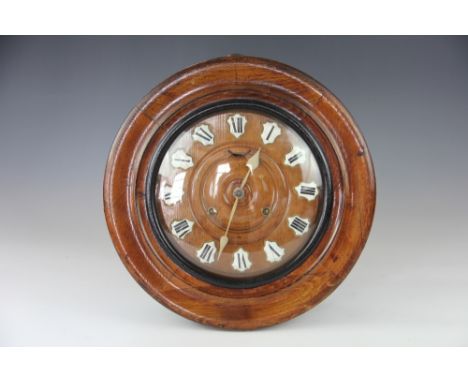 A late 19th century German oak wall clock, the turned dial with enamel and brass Roman numerals and movement striking upon a 