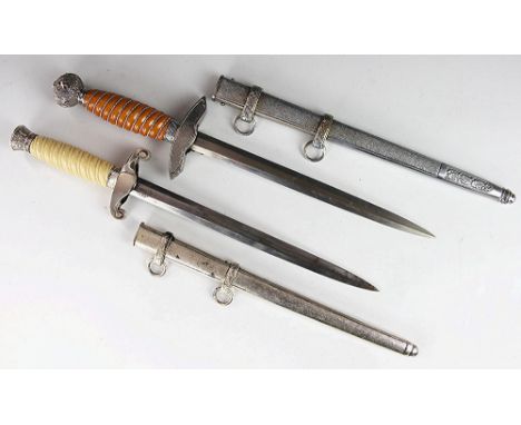 Two German Third Reich style daggers, comprising a luftwaffe dagger with scabbard and an Army Officers dagger with scabbard (