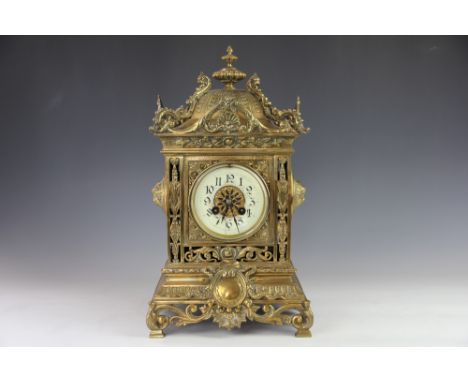 A 19th century brass eight day mantel clock, with Arabic chapter ring and movement stricking on a gong, the square section ca