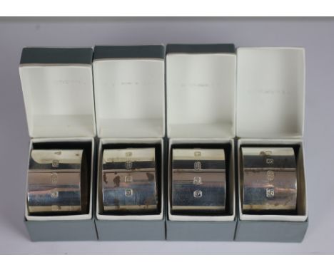 A set of four silver napkin rings, PC Ltd, London 2001, each of simple, plain form and within 'Pearl Cross, London' box, tota