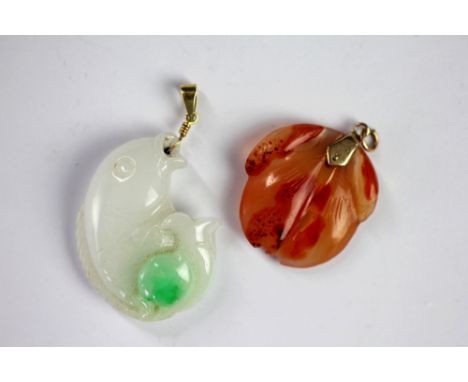A Jade pendant carved with a fish design, 4.5cm long and a further pendant carved with hanging fruit 3.2cm long (2) 