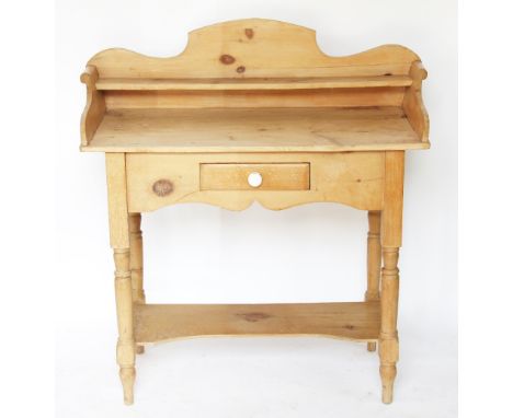 A pine wash stand, with raised single shelf back, above a drawer, on turned legs with under tier, 101cm H x 96cm W x 42cm D, 