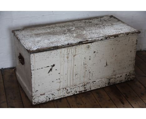 An Edwardian painted pine ships trunk, with twin loop handles, the underside of the lid decorated with a print of a tall ship