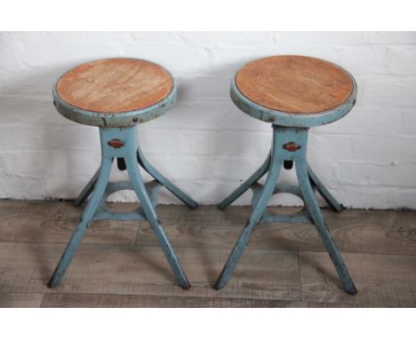 A pair of industrial laboratory stools by 'D. Mathews & Son' Liverpool, adjustable seats with wood inserts, lithograph makers