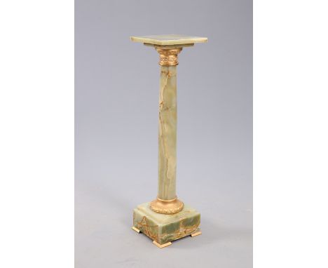 A GILT-METAL MOUNTED ONYX PEDESTAL, with square top and stepped square base with wreath cast collar and bracket feet. 101cm h