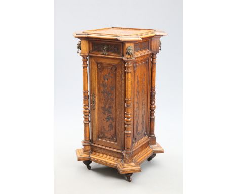 A 19TH CENTURY OAK PEDESTAL CUPBOARD, of square form with everted canted corners, the moulded top with beaded frame, the frie