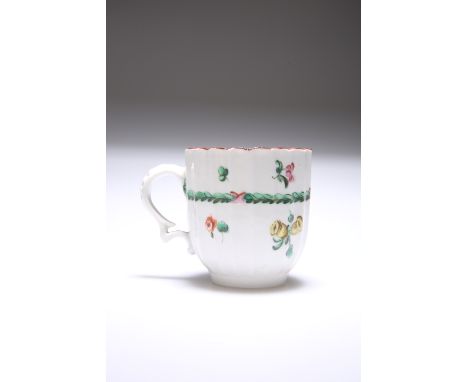 A BRISTOL HARD-PASTE FLUTED CUP, CIRCA 1770, enamel painted with floral sprigs and a ribbon tied garland beneath a red painte