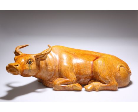 A LARGE CHINESE POTTERY MODEL OF A RECUMBENT WATER BUFFALO, ochre glazed. Approximately 58cm long