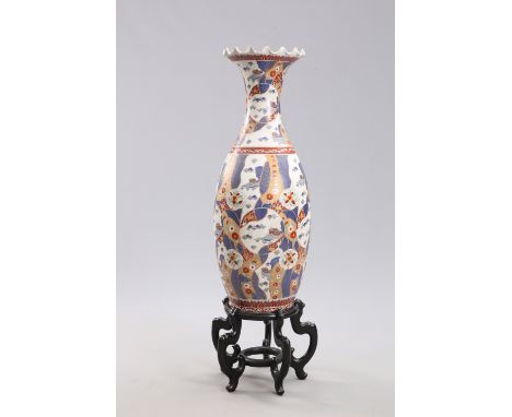 A LARGE JAPANESE IMARI FLOOR VASE,&nbsp;of baluster form with undulating rim to the flared neck, decorated in the characteris