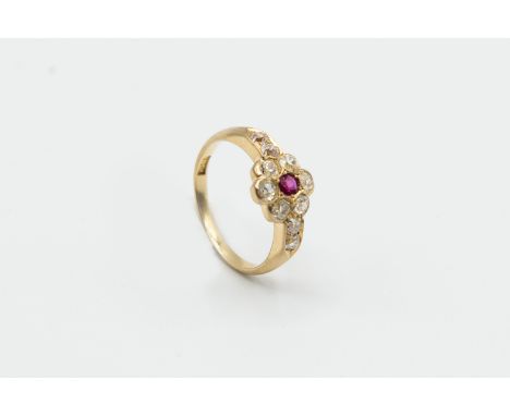 A RUBY AND DIAMOND RING, the single round mixed cut ruby highlight set within a surround of six old brilliant cut diamonds be