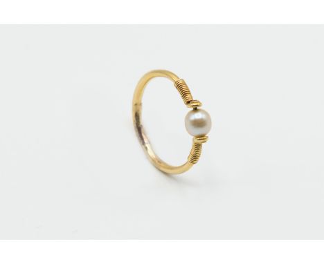 A NATURAL PEARL RING, the single natural pearl set simply between delicately moulded shoulders on a plain band. Ring size M. 