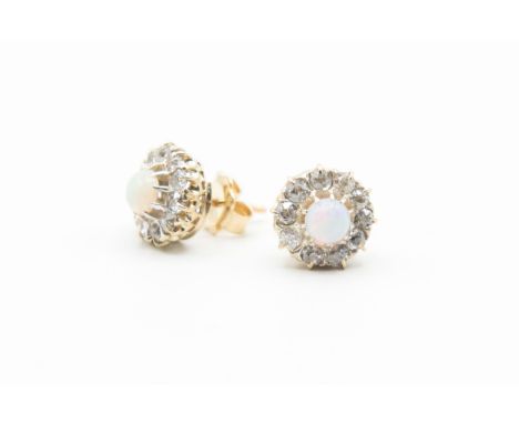 A PAIR OF OPAL AND DIAMOND EARRINGS, circa 1880-1890, the single opal set within a surround of ten old brilliant cut diamond 