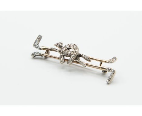A VICTORIAN DIAMOND SET BROOCH, the double hunting whip mounts each set with old cut diamond set highlights, set to the centr